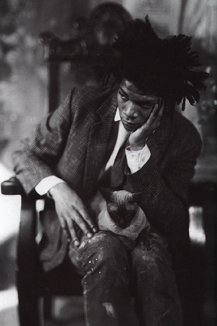 Photo of Basquiat holding a cat looking worried